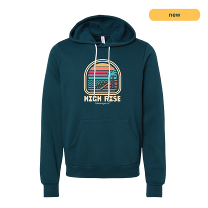 Navy hoodie with a colorful graphic and 'High Rise' text. Graphic is a sunrise on a beachfront with a palm tree, style of graphic is retro.
