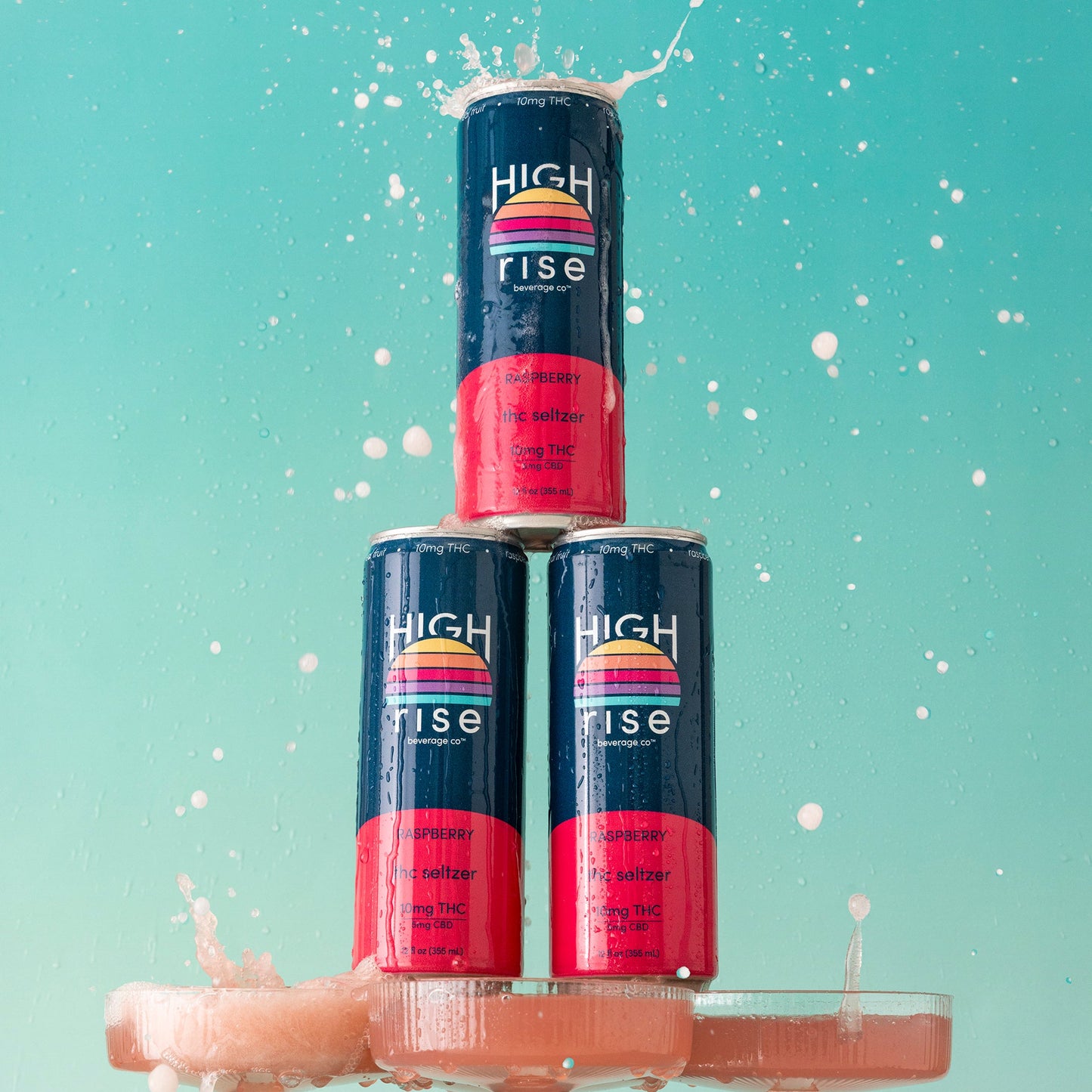 Three cans of High RIse Raspberry 10mg THC Seltzer on champagne glasses with a light blue background.